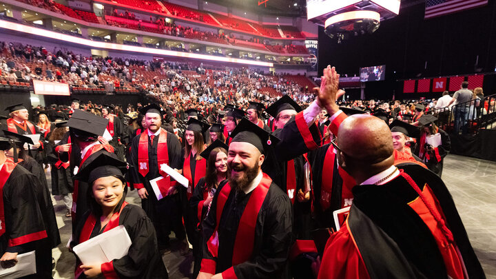 Chancellor Rodney Bennett high-fiving students at undergraduate commencement