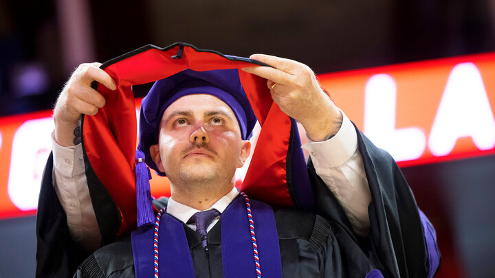 Graduate receiving decoration at Law Commencement