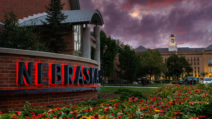 University of Nebraska sign lit up at night at Visitors Center