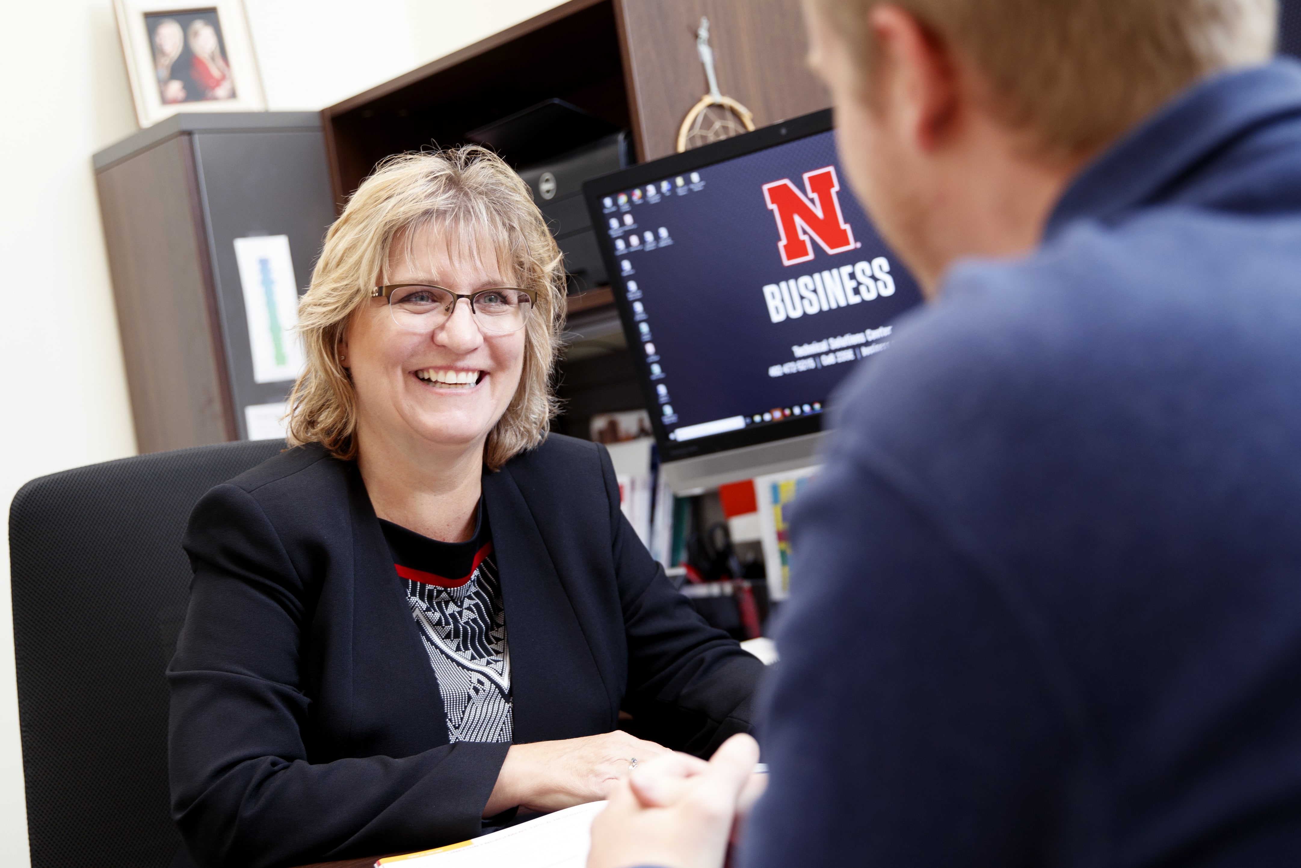 woman at desk smiling