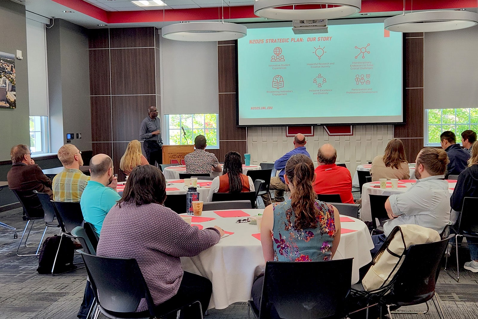 people in a room listening to a presentation