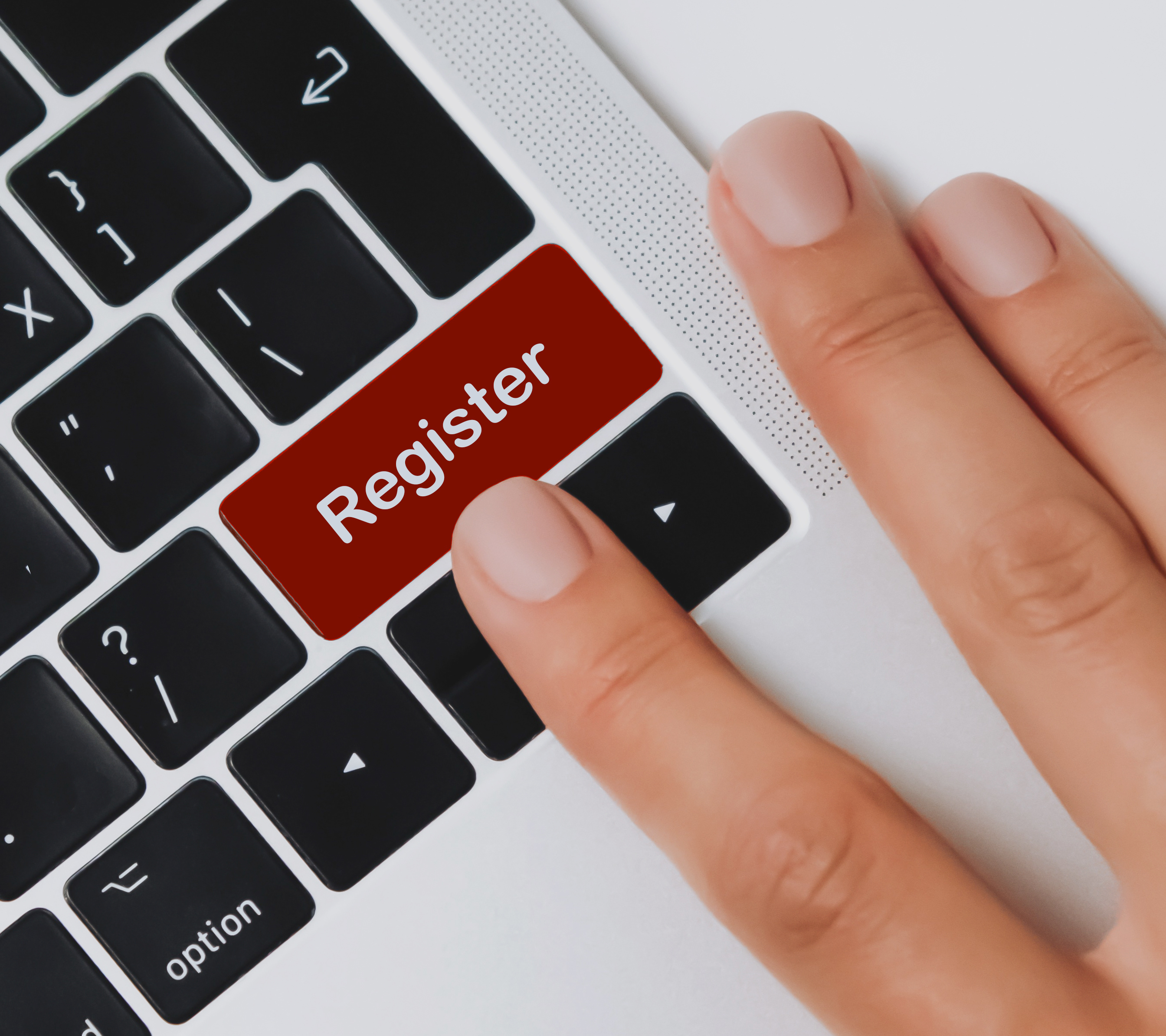 computer keyboard with finger on Register button