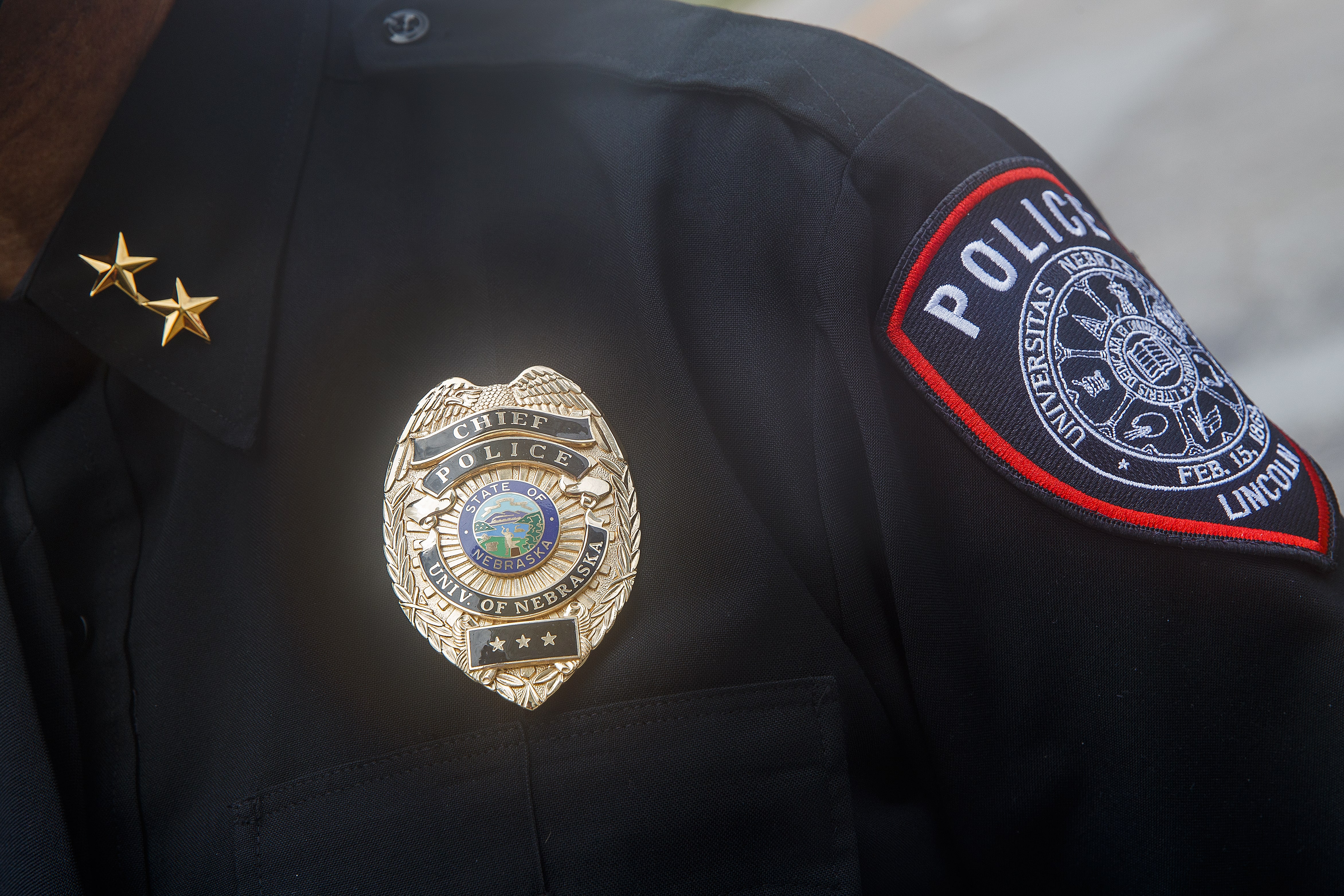 police badge and patch on uniformed shoulder