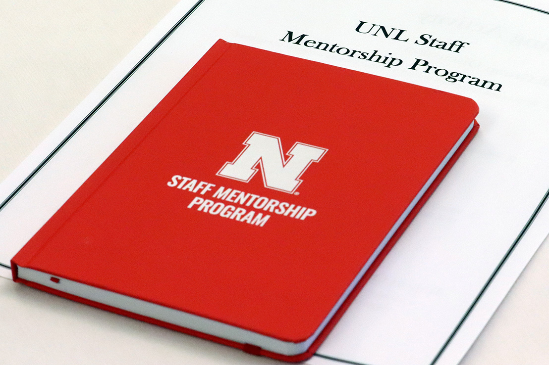 Staff Mentorship Program notebook on table