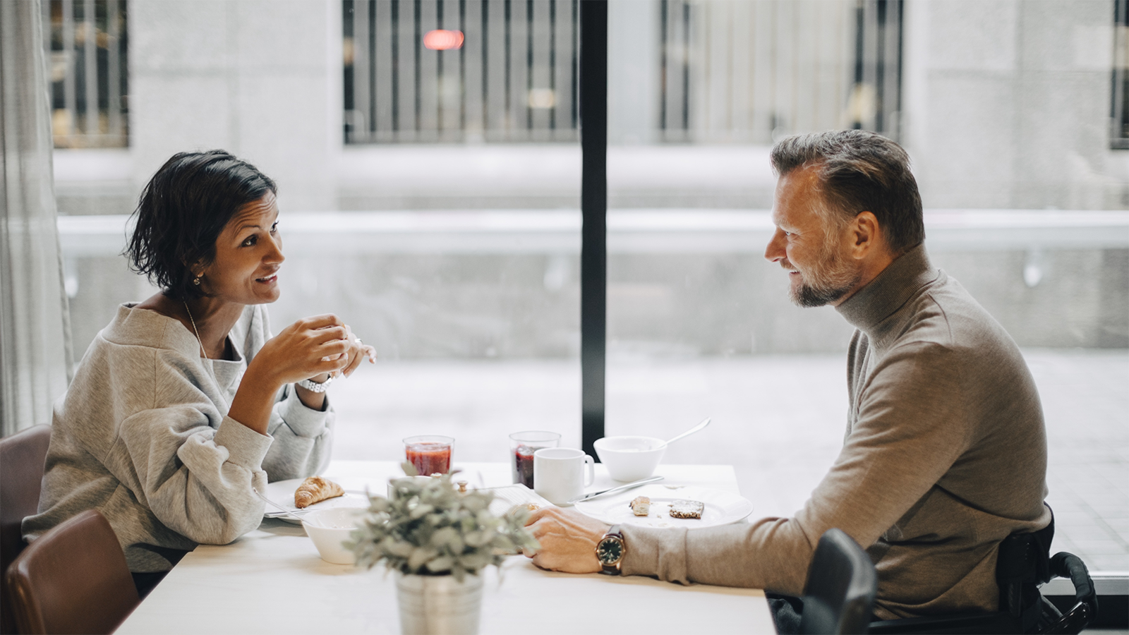 two people talking over coffee