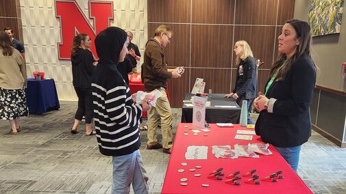 people talking at a display table
