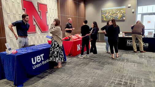 people talking at a display table