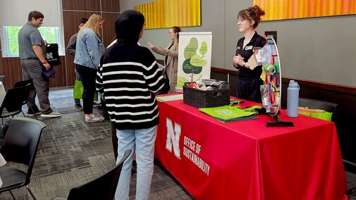 people talking at a display table