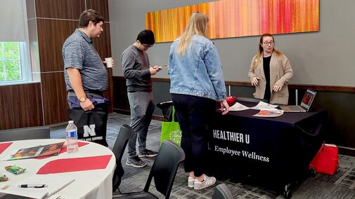 people talking at a display table