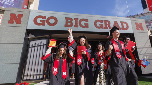people graduating in gate to stadium