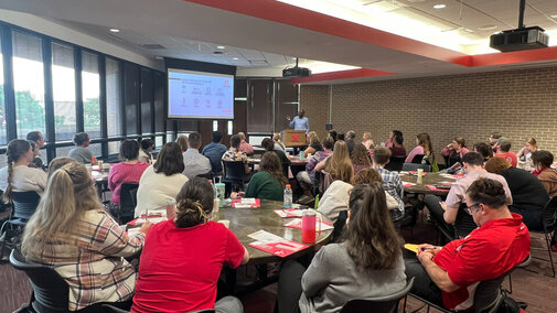 Staff and faculty in room for orientation