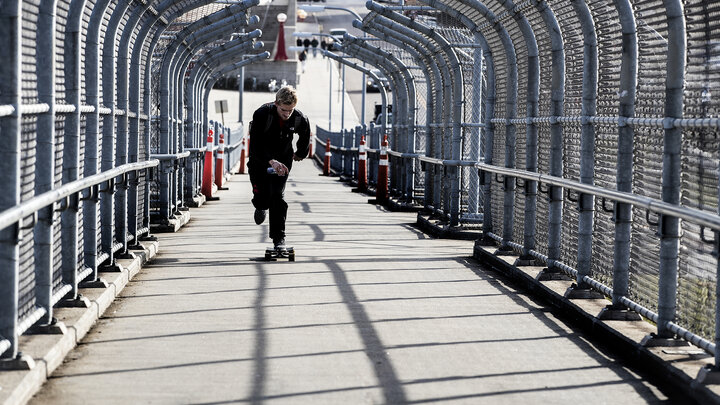 A skateboarder accelerates up the 10th Street pedestrian bridge. The walkway will be closed for a maintenance project on Feb. 20.