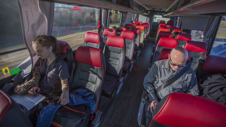 Natalija Ward (left) and Tim Terrell work on computers as the N-E Ride shuttle glides down Interstate 80 near Mahoney State Park. The shuttle runs 8 a.m. to 6 p.m. weekdays.