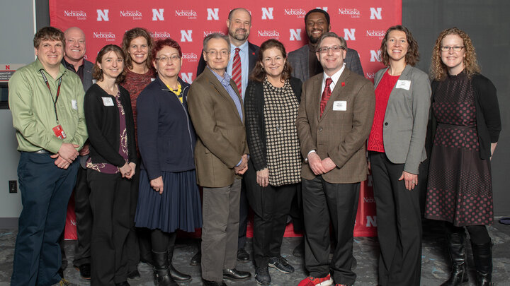 A group of Nebraska faculty and staff pose for a photo during the Parents' Association awards.