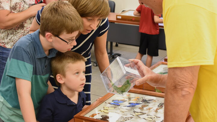 Entomology Research Technologist Steve Spomer shows a butterfly to guests at Bugfest 2016.