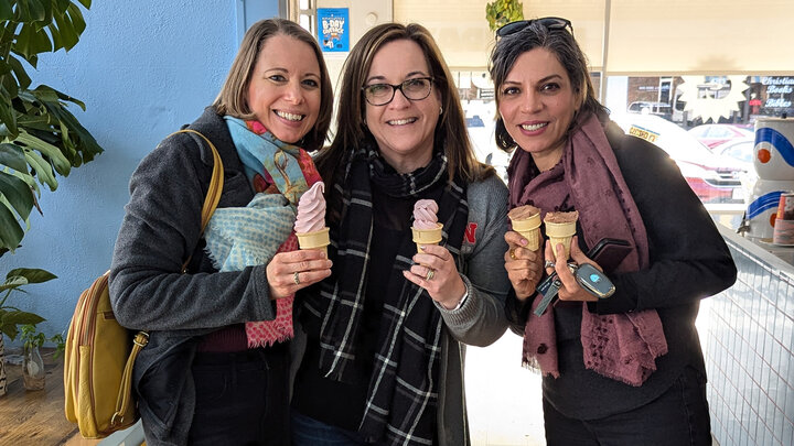 Nebraska's Sabrina Ehmke Sergeant (left) stands with two friends, each enjoying an ice cream cone in an ice cream store.