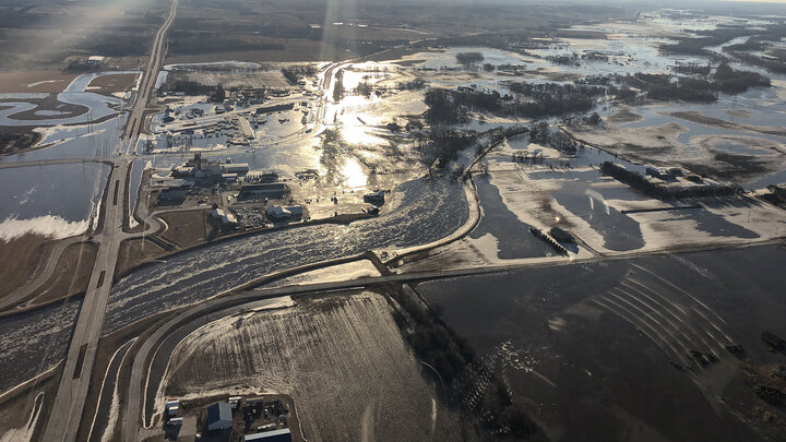 Flood water runs across roadways and into a Nebraska community after storms hit the region in March. The University of Nebraska has established programs to help students, faculty and staff impacted by the historic storms. The university is also offering students and employees opportunities to help with the recovery effort.