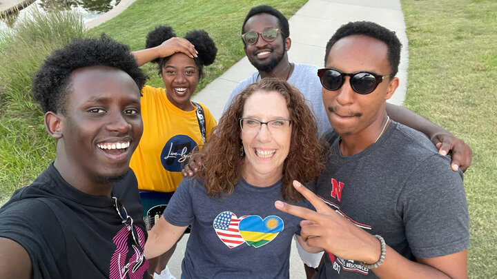 Nebraska's Mikki Sandin stands with Huskers during a Rwandan Student Association concert.