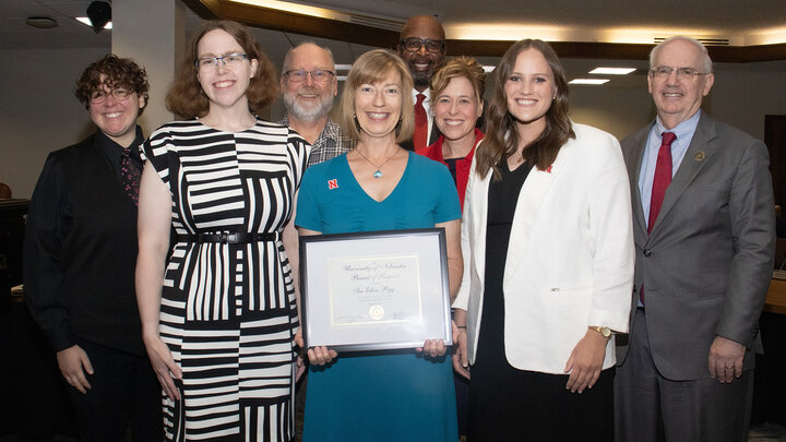 Sue Ellen Pegg received the Kudos award during the June 19 meeting of the University of Nebraska Board of Regents. She is pictured here (front, center) with family, friends, colleagues and university leaders.