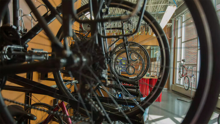 Bikes hang in the Outdoor Adventures Center bike shop. A new community partnership is bringing a bike-share service to campus this spring.
