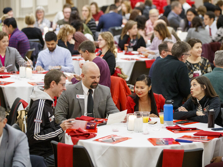group of diverse people sitting around a table talking
