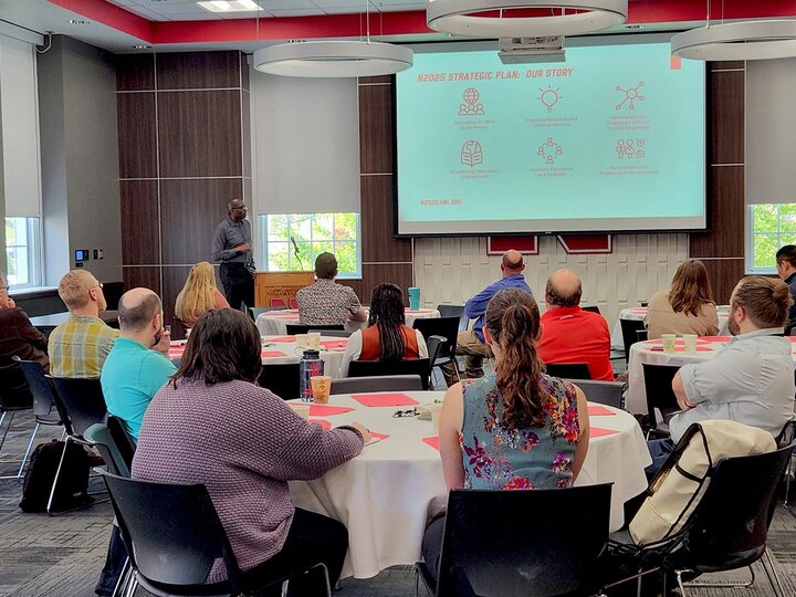 people in a room listening to a presentation