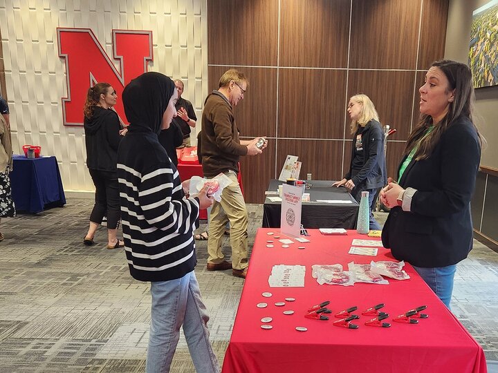 people talking at a display table