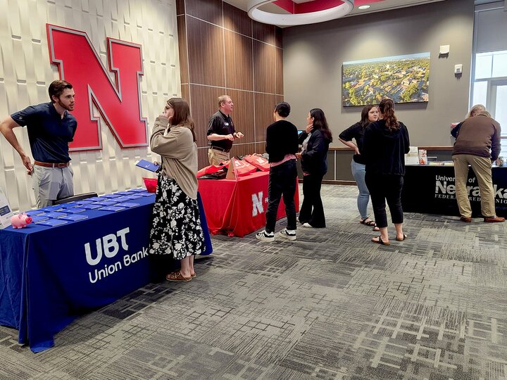 people talking at a display table