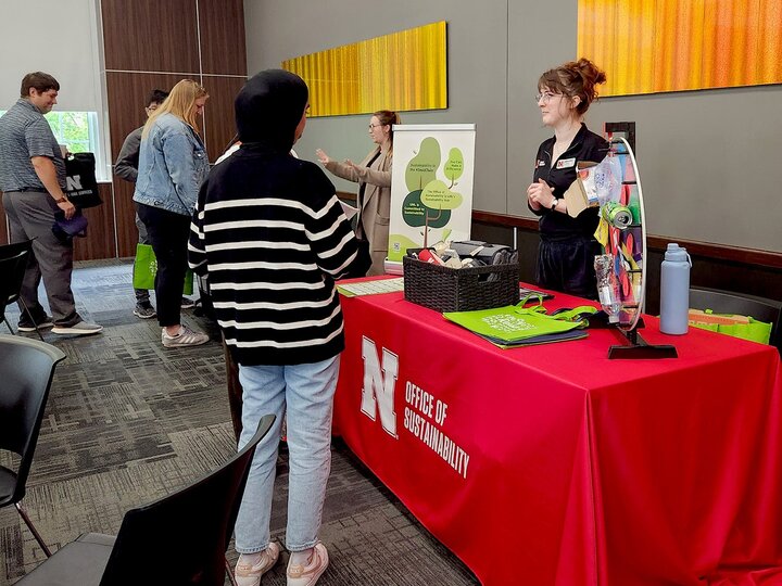 people talking at a display table