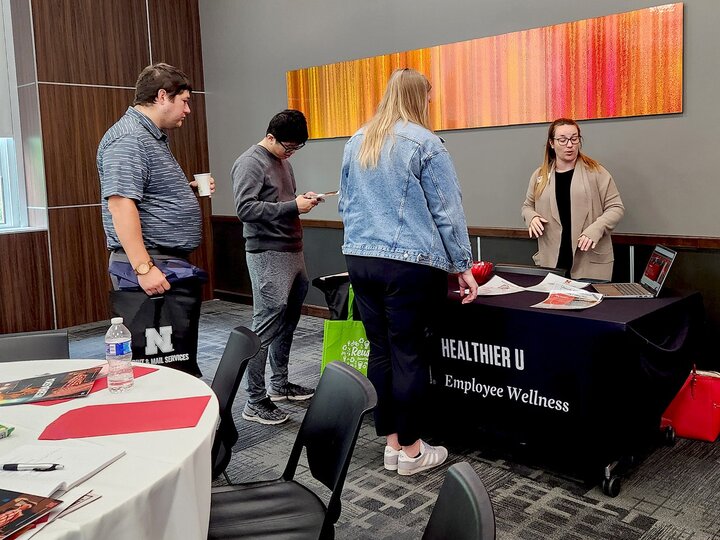 people talking at a display table