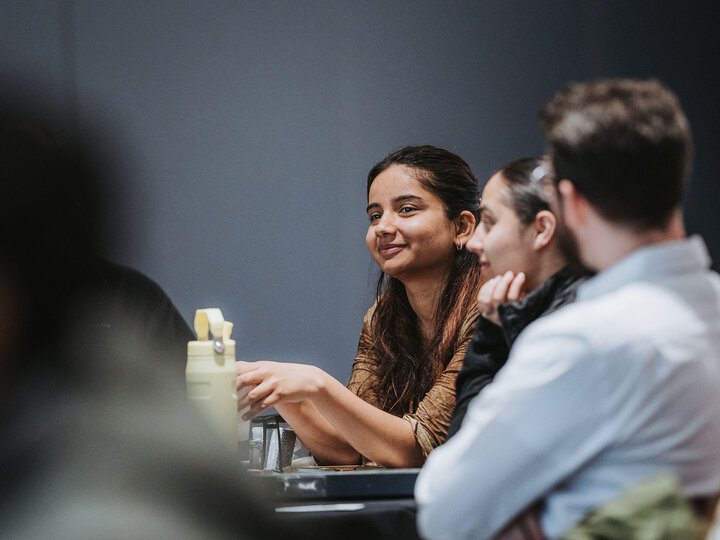 Staff members sitting at table and talking