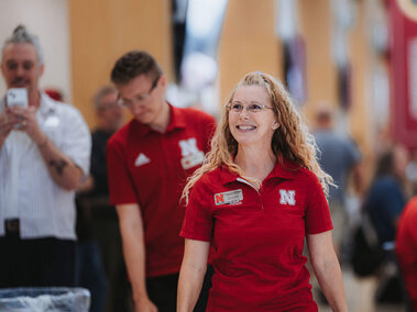 Staff member smiling and walking to receive award